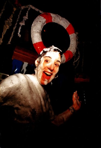 Beneath the lifebuoy of the set, a face covered in foam.