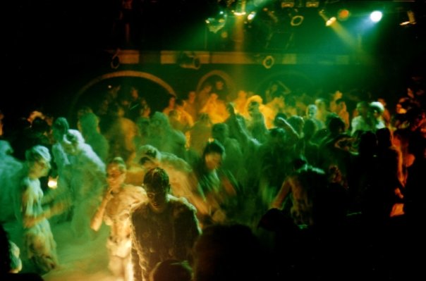 Overall view of the Fuse dance floor covered in foam, under the green lights.