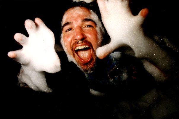 A clubber, hands gloved in foam, facing the camera.