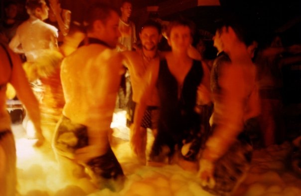 Dancers together in the foam rising up to their legs, in the middle of the floor.