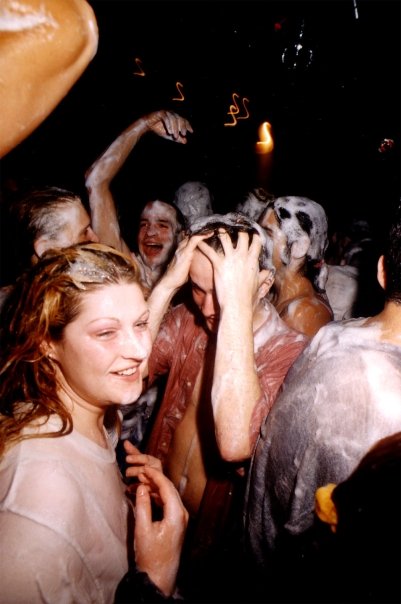 Laughter in the middle of the crowd, hair and faces covered in foam.