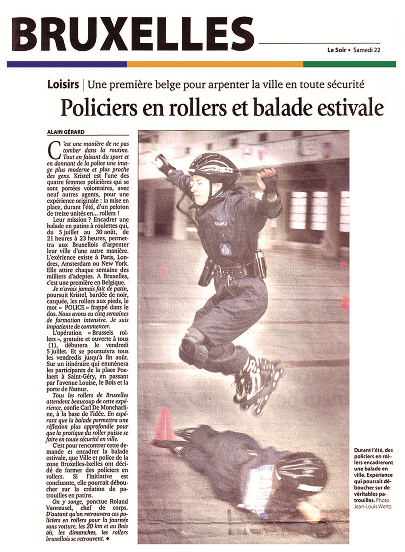 Le Soir, June 22, 2002. Photograph of a policewoman in training, jumping over another officer on the ground between cones, by Jean-Louis Wertz.