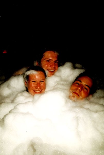 Three faces emerging from a wave of foam on the Fuse dance floor.