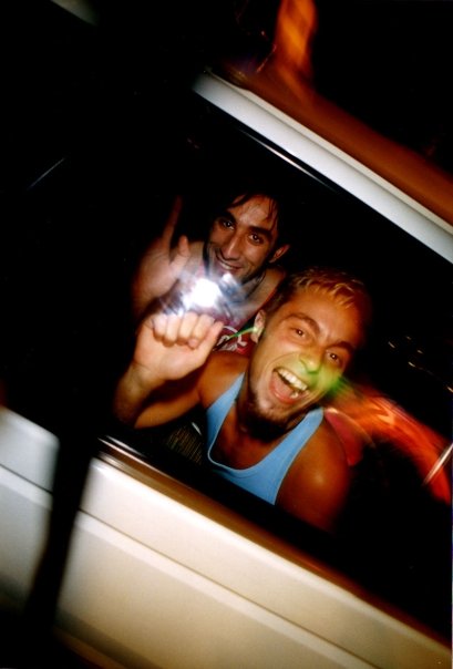 Yorgo and a friend at the end of the night, through a car window.