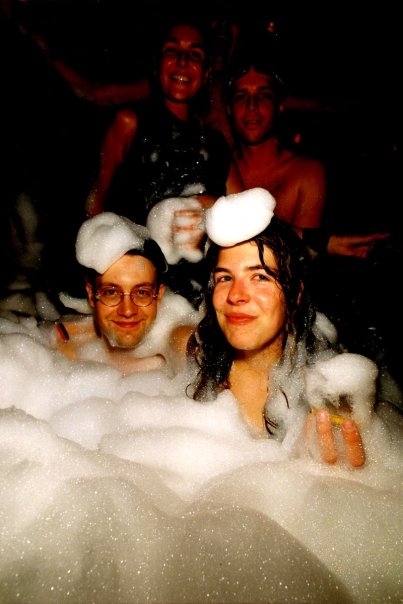Dancers immersed up to their shoulders in the foam.