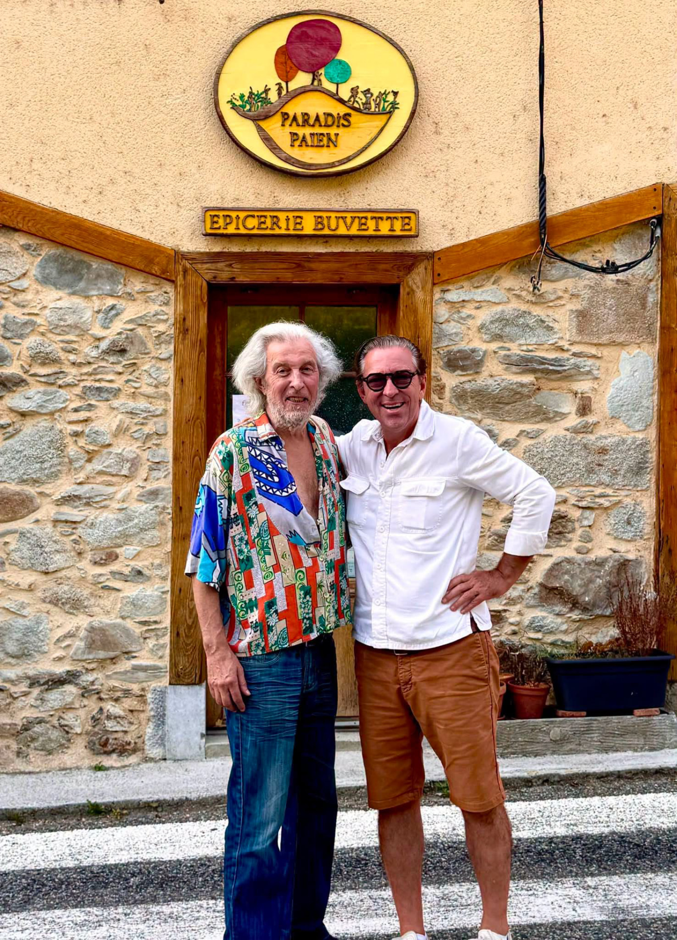 Jean-Pierre Mels and Carl De Moncharline in front of the Paradis Paien, a grocery-café in the Pyrenees.